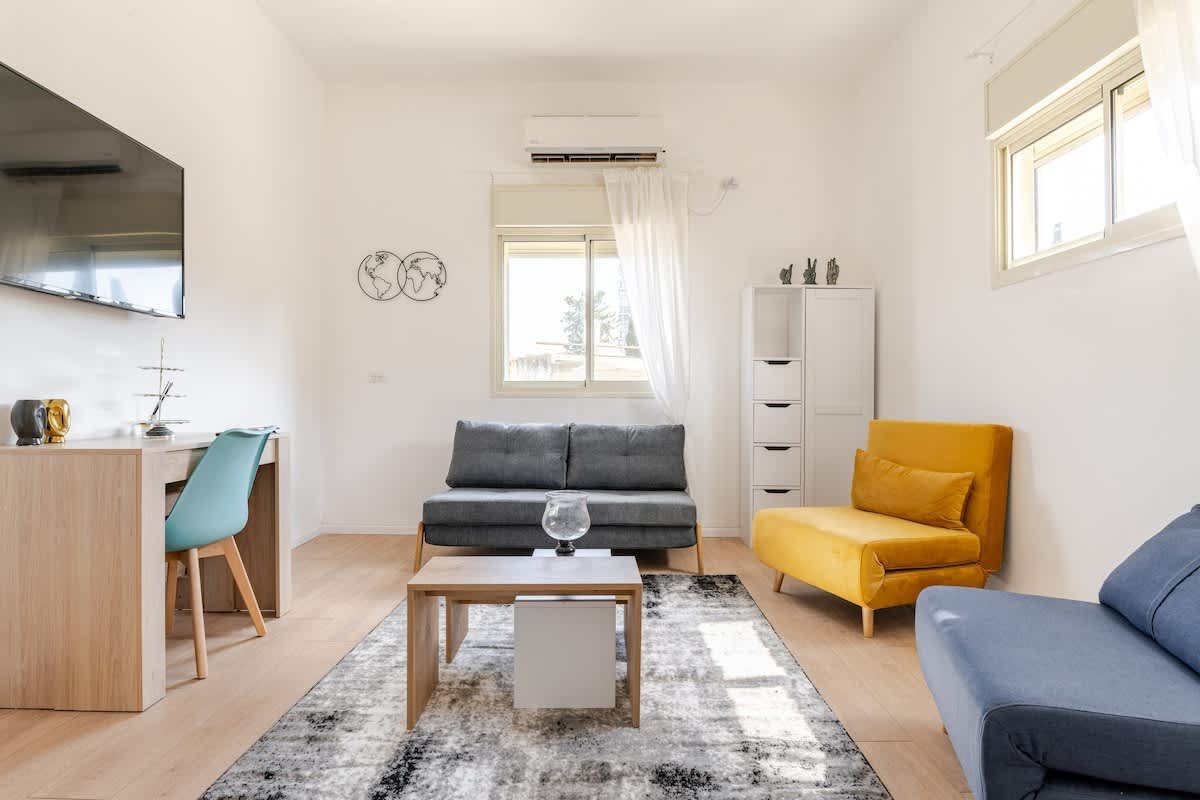 living room with sofa, TV and desk, Qawra Shore Studio, Malta